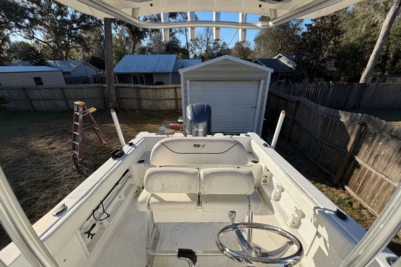 Slide: The Image of 2015 Sea Hunt Ultra 225 boat in backyard, near storage shed and ladder. - 53