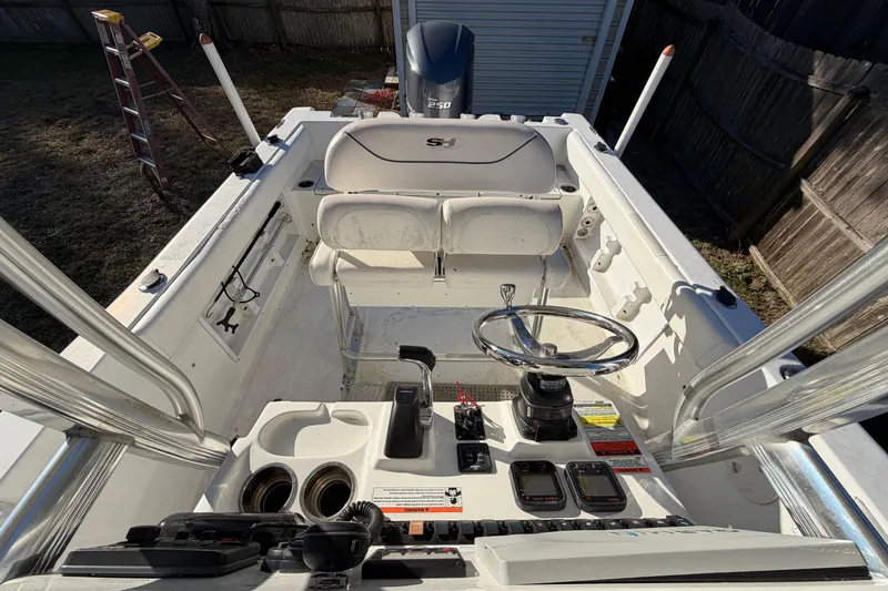 Slide: The Image of 2015 Sea Hunt Ultra 225 boat cockpit with steering wheel and controls. - 54
