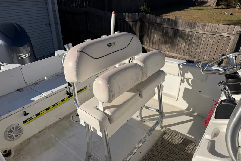 Slide: The Image of 2015 Sea Hunt Ultra 225 boat interior with seating and steering wheel. - 55