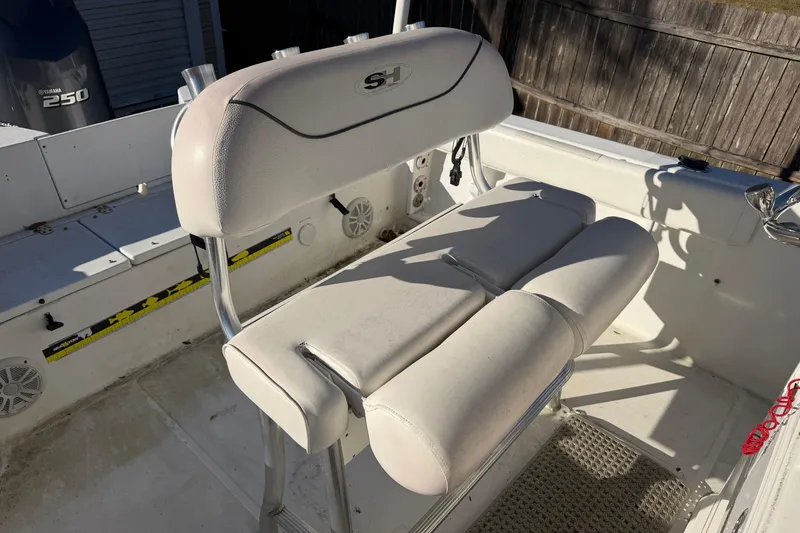 Slide: The Image of 2015 Sea Hunt Ultra 225 boat interior with cushioned seating and Yamaha 250 engine. - 56