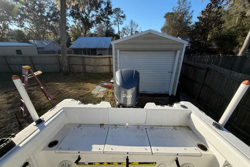 Slide: The Image of 2015 Sea Hunt Ultra 225 boat with Yamaha 250 engine in a backyard setting. - 57