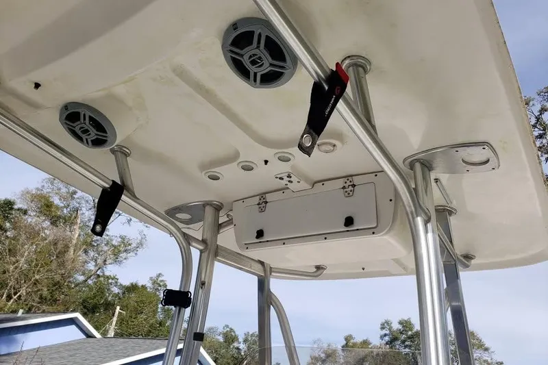 Slide: The Image of 2015 Sea Hunt Ultra 225 boat with Yamaha four-stroke outboard motor in a backyard setting. - 7
