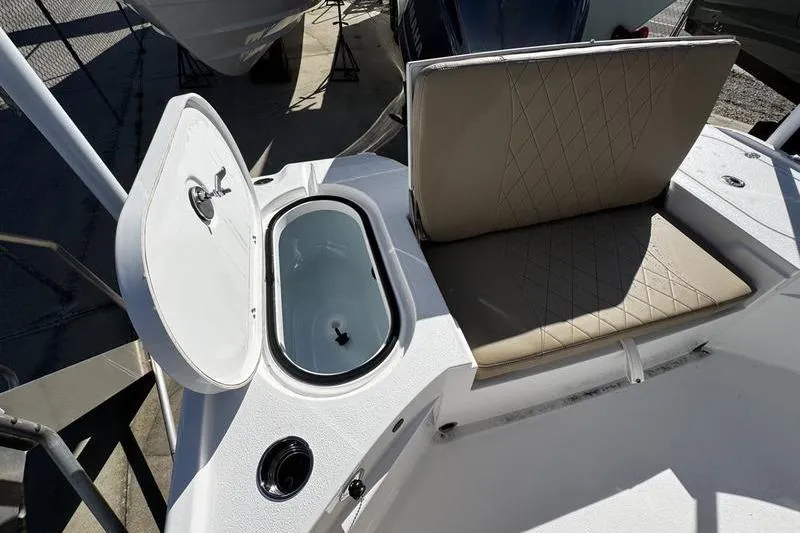 Slide: The Image of 2026 Blazer Bay 2400 boat with open storage compartment and cushioned seating. - 23