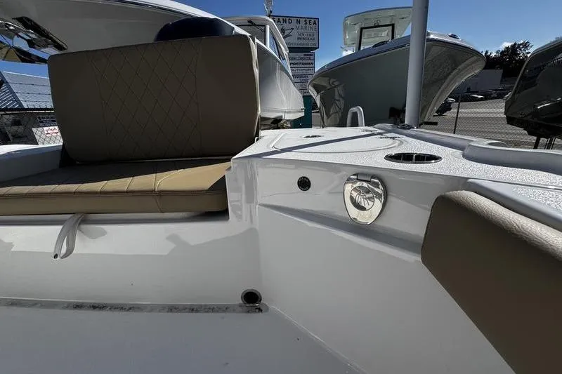 Slide: The Image of 2026 Blazer Bay 2400 boat interior with tan seating and white deck. - 24