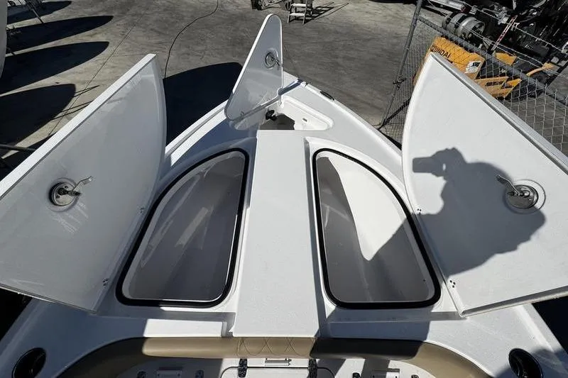 Slide: The Image of 2026 Blazer Bay 2400 boat with open storage compartments on deck. - 8