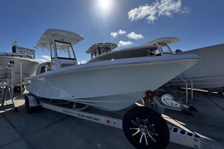 The Image of 2026 Blazer Bay 2400 boat on trailer under sunny sky at marina. - 1