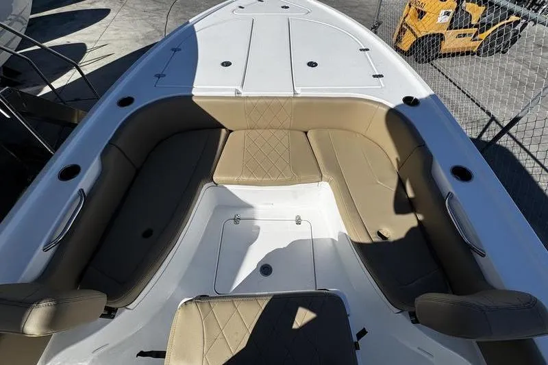 Slide: The Image of 2026 Blazer Bay 2400 boat interior with tan seating and white deck. - 12