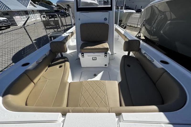 Slide: The Image of 2026 Blazer Bay 2400 boat interior with tan cushioned seating and storage compartments. - 13