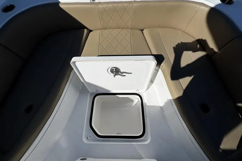 Slide: The Image of 2026 Blazer Bay 2400 boat interior with storage compartment and beige seating. - 16
