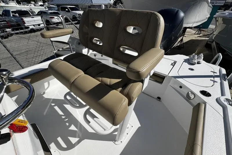 Slide: The Image of 2026 Blazer Bay 2400 boat interior with tan seating and steering wheel. - 19