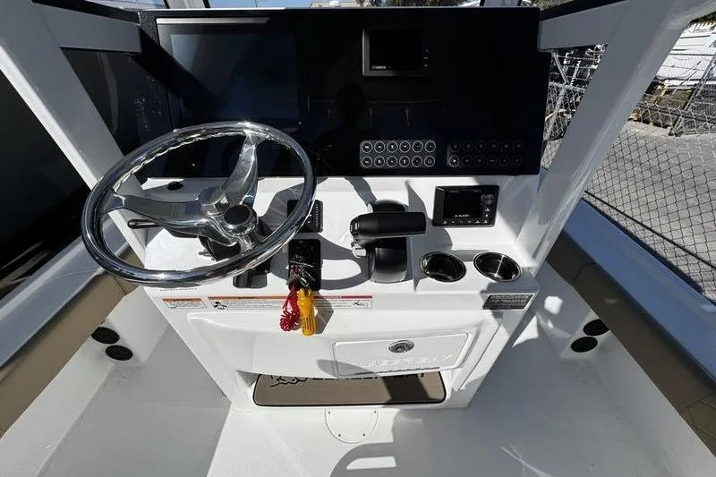 Slide: The Image of 2026 Blazer Bay 2400 boat console with steering wheel and controls. - 22