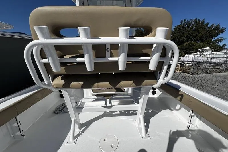 Slide: The Image of 2026 Blazer Bay 2400 boat seating with rod holders, white and beige design. - 25