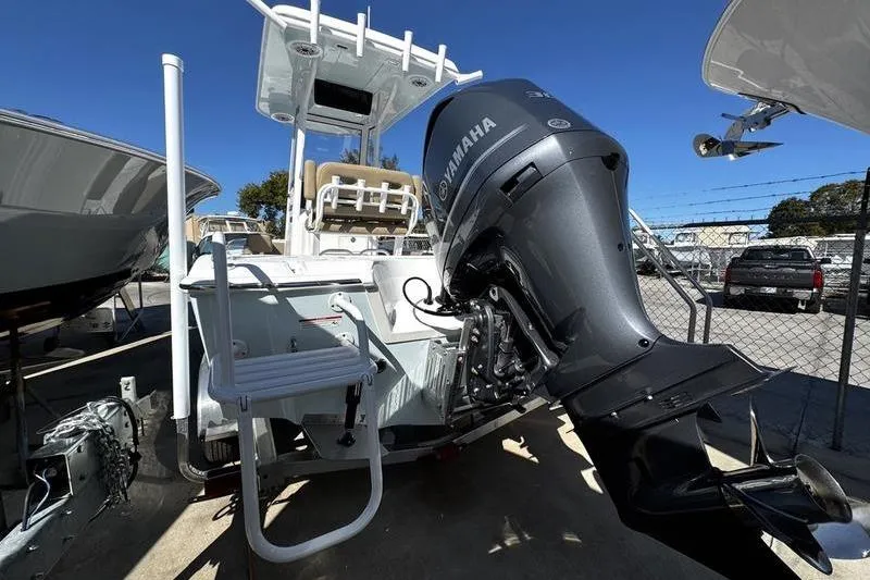 Slide: The Image of 2026 Blazer Bay 2400 boat with Yamaha outboard motor, docked outdoors. - 4