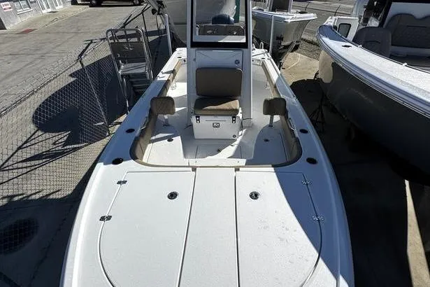 Slide: The Image of 2026 Blazer Bay 2400 boat with spacious deck and seating, docked outdoors. - 7