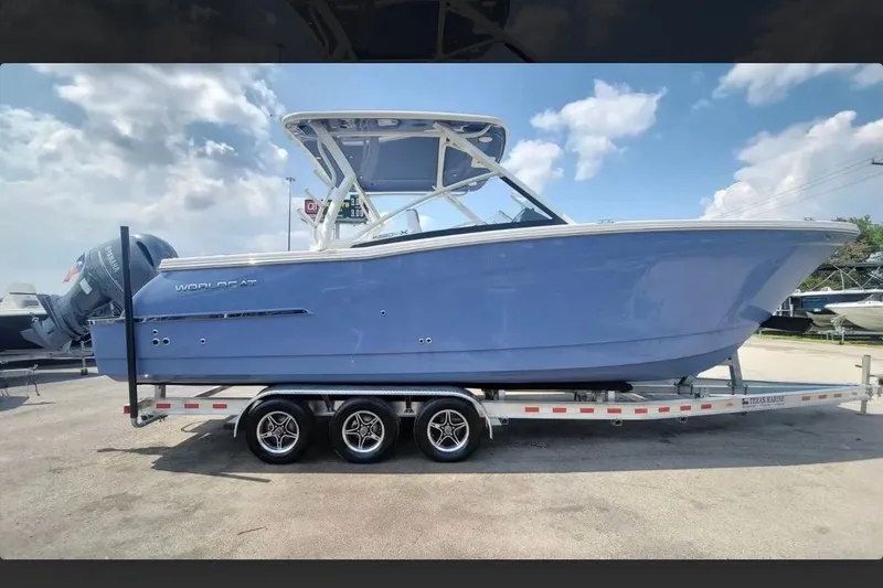 The Image of 2023 World Cat 280 DC-X boat on trailer under blue sky. - 0