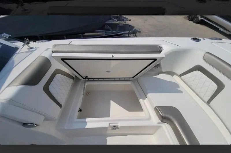 Slide: The Image of 2023 World Cat 280 DC-X boat interior with open storage compartment and cushioned seating. - 10