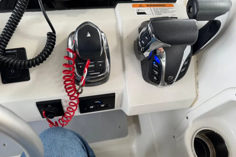 Slide: The Image of Control panel of 2023 World Cat 280 DC-X boat with throttle and switches. - 12