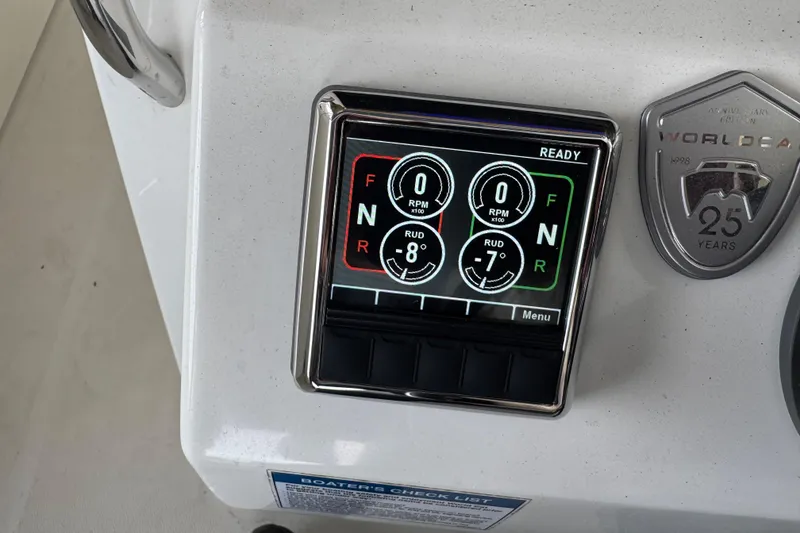 Slide: The Image of Control panel of 2023 World Cat 280 DC-X boat with digital display and anniversary badge. - 13