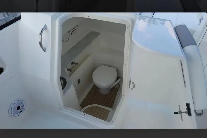 Slide: The Image of 2023 World Cat 280 DC-X boat interior with compact marine toilet. - 18