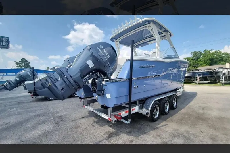 Slide: The Image of 2023 World Cat 280 DC-X boat on trailer with Yamaha engines, parked outdoors. - 3