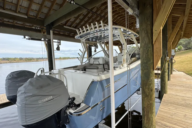 Slide: The Image of 2023 World Cat 280 DC-X boat docked under wooden shelter with Yamaha engines. - 30