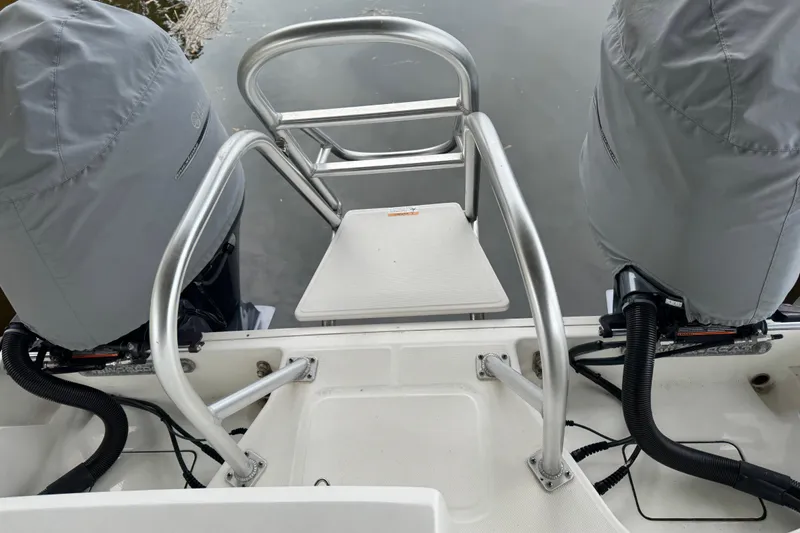 Slide: The Image of 2023 World Cat 280 DC-X boat with dual covered engines and rear boarding ladder. - 8