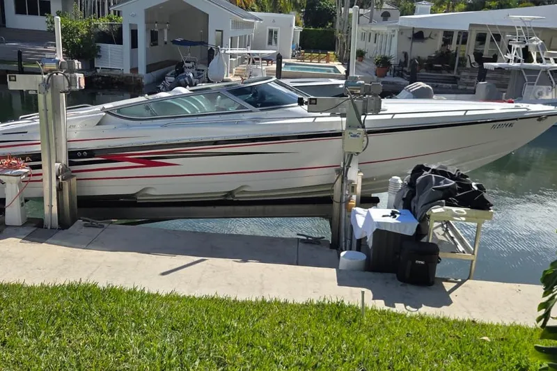 The Image of 2004 Formula 292 FASTech boat docked in a residential canal setting. - 0