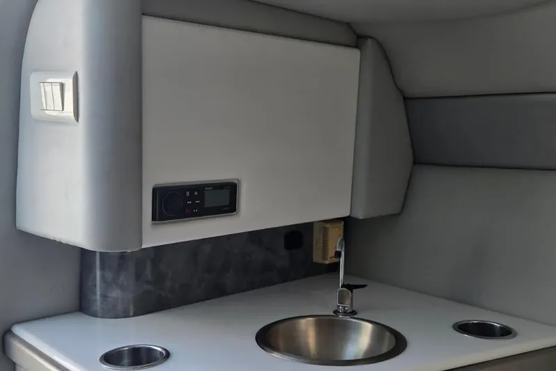 Slide: The Image of 2004 Formula 292 FASTech boat docked, featuring sleek design and vibrant red, white, and blue stripes. - 13