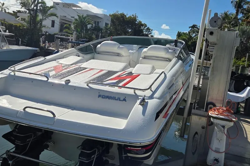 Slide: The Image of 2004 Formula 292 FASTech boat docked near waterfront homes. - 18