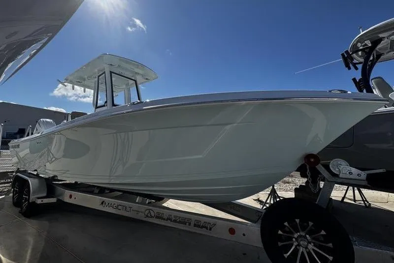 The Image of 2026 Blazer Bay Makaira 2800 boat on trailer under clear blue sky. - 1