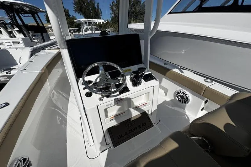 Slide: The Image of 2026 Blazer Bay Makaira 2800 boat cockpit with steering wheel and controls. - 14