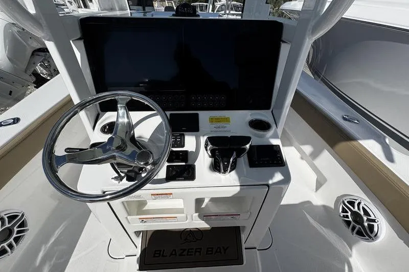 Slide: The Image of 2026 Blazer Bay Makaira 2800 boat helm with steering wheel and control panel. - 15