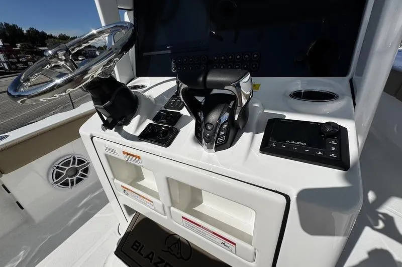 Slide: The Image of 2026 Blazer Bay Makaira 2800 boat console with steering wheel and controls. - 16