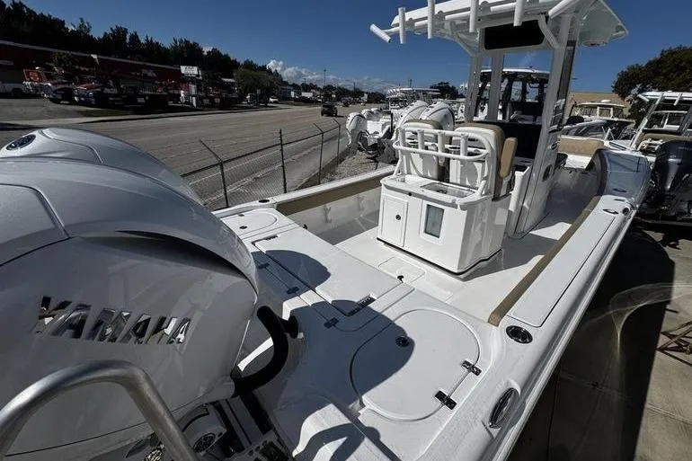 Slide: The Image of 2026 Blazer Bay Makaira 2800 boat with Yamaha engine, docked outdoors. - 2