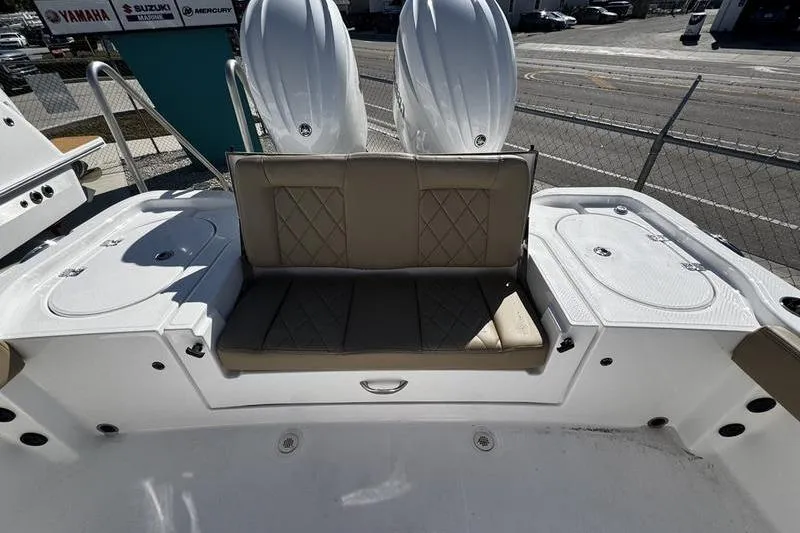 Slide: The Image of 2026 Blazer Bay Makaira 2800 boat interior with cushioned seating and dual engines. - 22