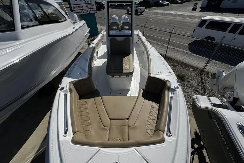 Slide: The Image of 2026 Blazer Bay Makaira 2800 boat with tan seating, docked outdoors. - 7