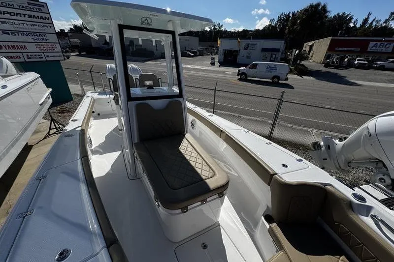 Slide: The Image of 2026 Blazer Bay Makaira 2800 boat with cushioned seating, docked at a marina. - 8