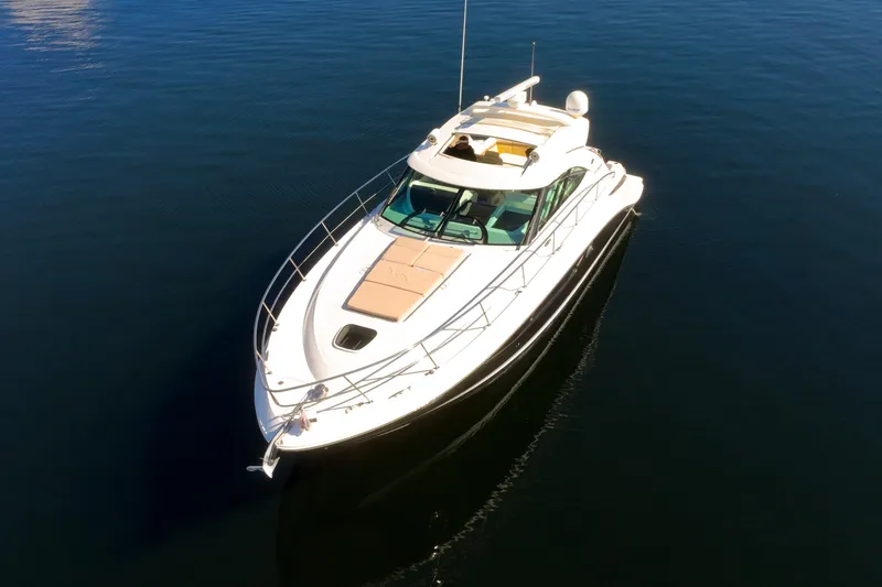 Slide: The Image of 2015 Sea Ray 410 Sundancer yacht on calm blue water, aerial view. - 12