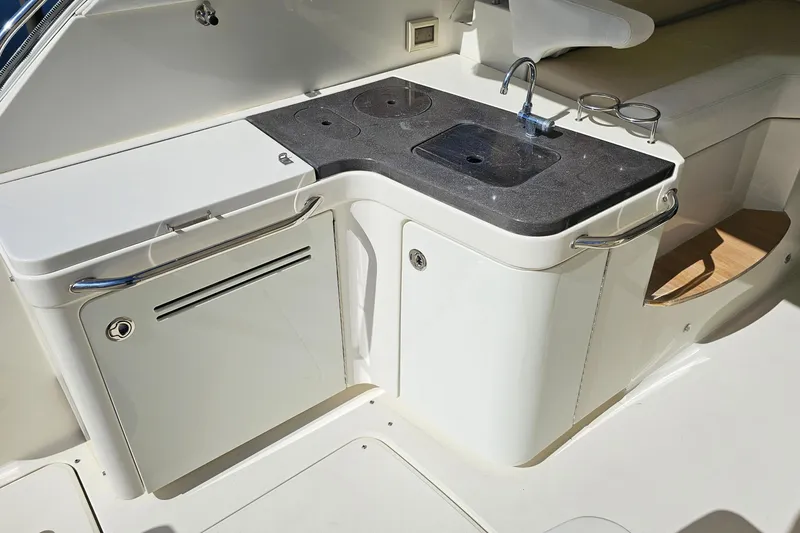 Slide: The Image of Outdoor kitchenette on 2015 Sea Ray 410 Sundancer yacht with sink and storage. - 22
