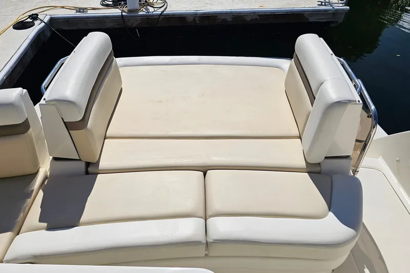 Slide: The Image of Luxury seating on a 2015 Sea Ray 410 Sundancer boat, docked by the water. - 25