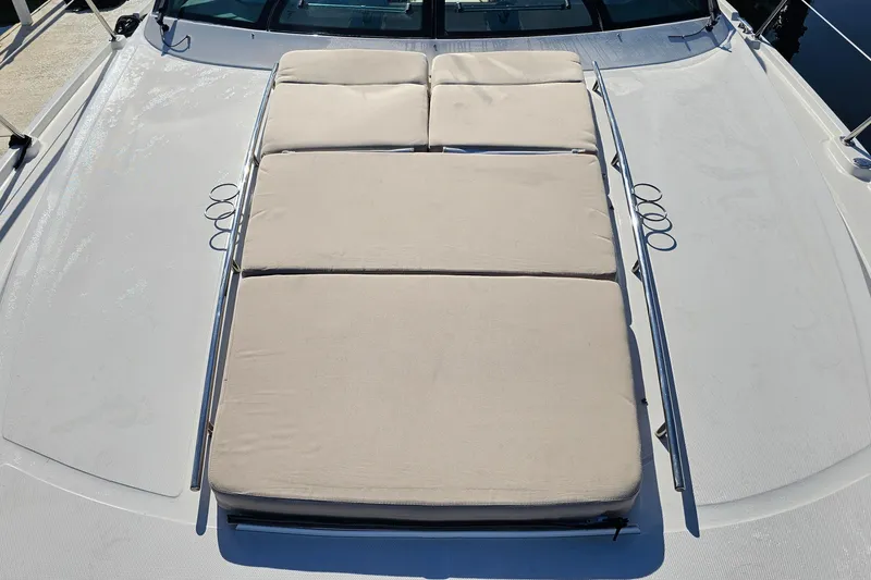 Slide: The Image of Sunpad on 2015 Sea Ray 410 Sundancer yacht, featuring beige cushions and stainless steel rails. - 29