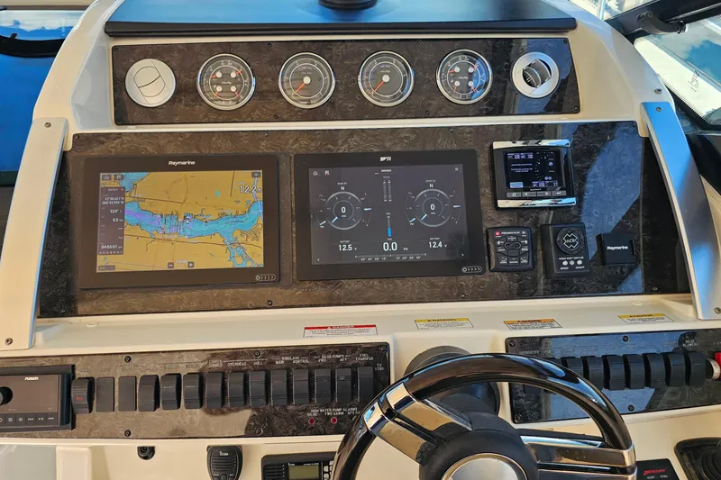 Slide: The Image of 2015 Sea Ray 410 Sundancer dashboard with navigation and control panels. - 33