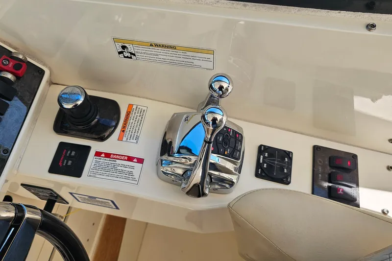 Slide: The Image of Control panel of a 2015 Sea Ray 410 Sundancer boat with chrome throttle levers. - 35