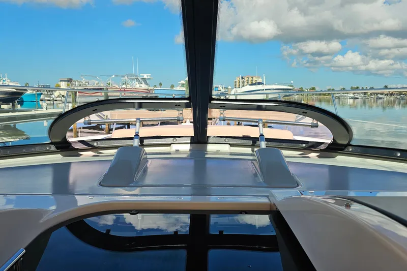 Slide: The Image of 2015 Sea Ray 410 Sundancer yacht docked at marina under blue sky. - 37
