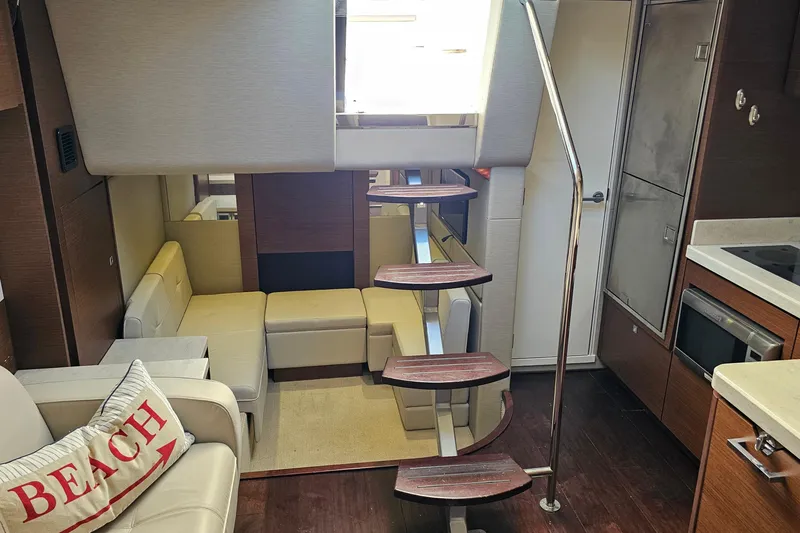 Slide: The Image of Luxurious interior of 2015 Sea Ray 410 Sundancer yacht with modern seating and kitchen. - 39