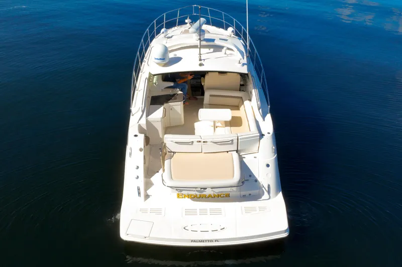 Slide: The Image of 2015 Sea Ray 410 Sundancer yacht on calm blue water, aerial view. - 4