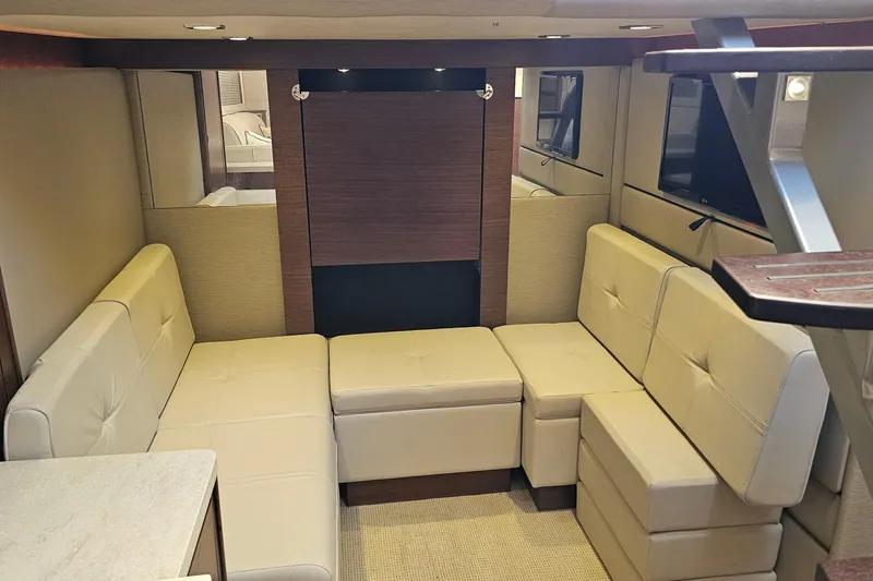 Slide: The Image of Luxurious interior of 2015 Sea Ray 410 Sundancer yacht with beige leather seating. - 40