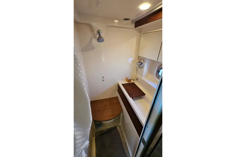 Slide: The Image of Bathroom interior of 2015 Sea Ray 410 Sundancer yacht, featuring shower and sink. - 45