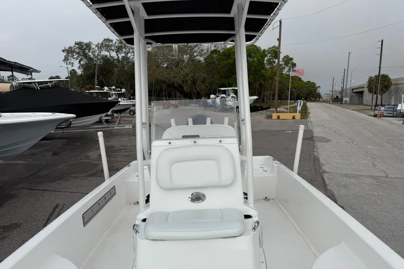 Slide: The Image of 2022 Clearwater 2100 Baystar boat parked in a marina with American flag in background. - 11