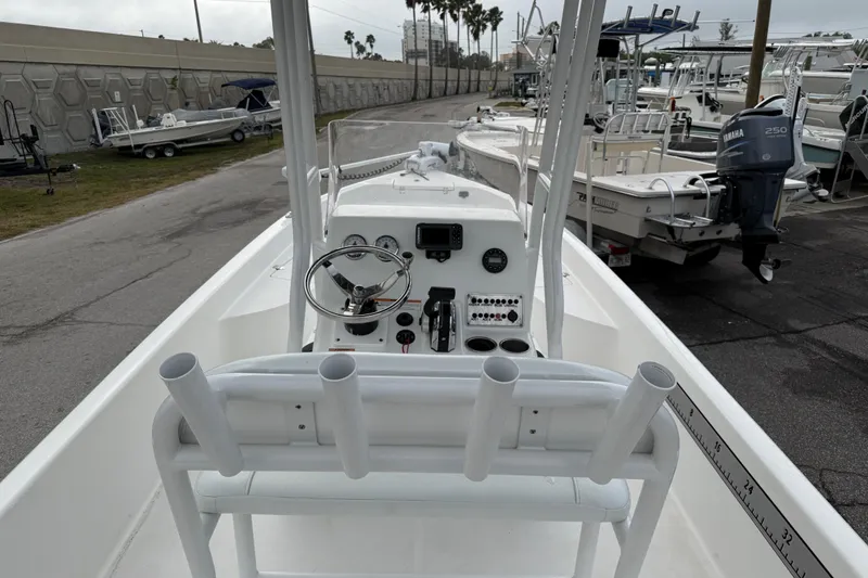 Slide: The Image of 2022 Clearwater 2100 Baystar boat interior with steering console and rod holders. - 8